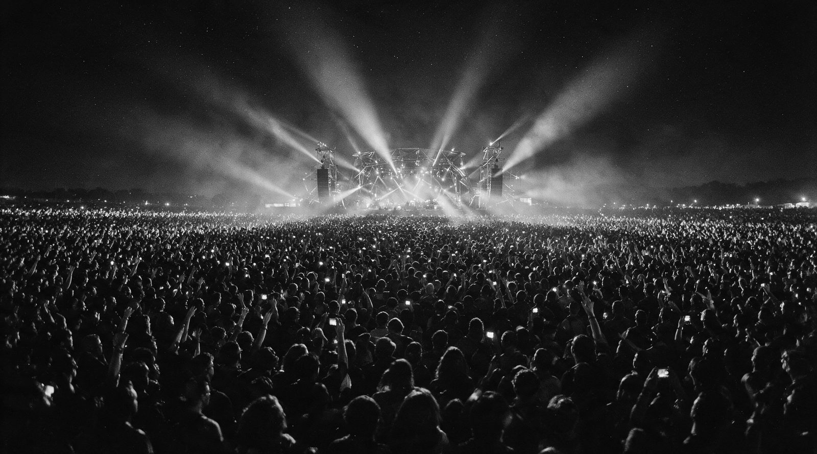 The UNTOLD main stage at night, seen from above the crowd, in black and white.